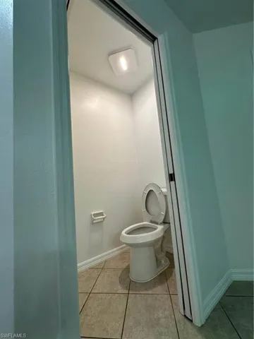 Bathroom with light tile patterned flooring
