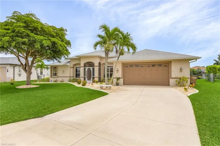 View of front of house with a garage and large driveway for parking for visitors and parties!