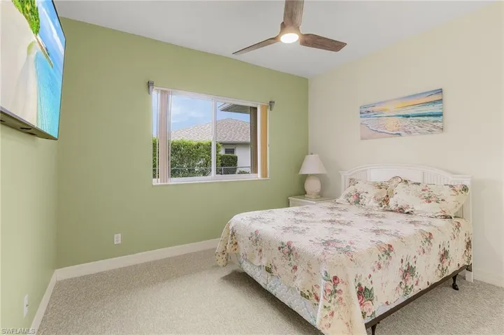 Guest bedroom w/ new carpet and new fan.