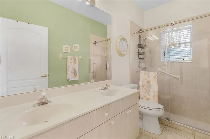Guest bath w/ new glass shower doors double sinks.