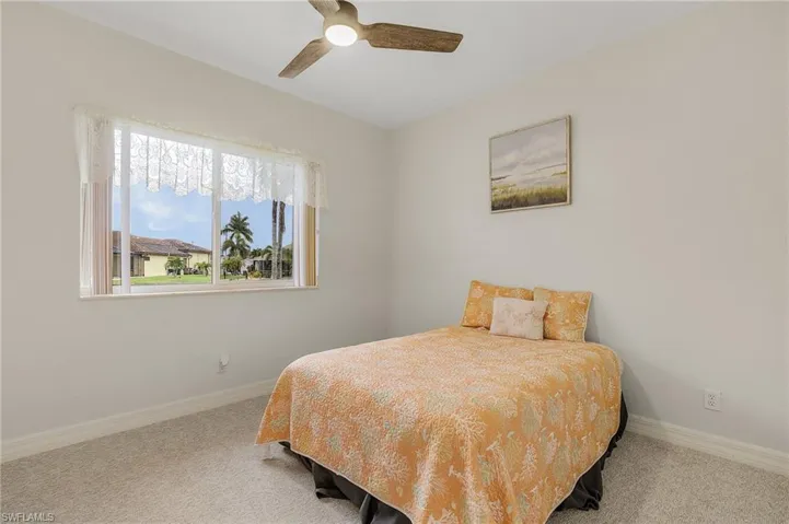 Guest bedroom w/ new carpet and new fan.