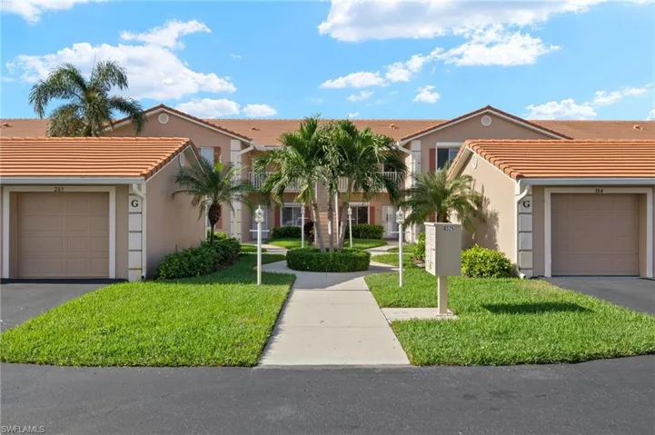 View of front facade with a front yard and a garage