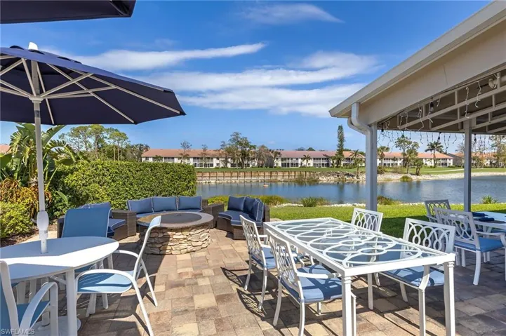 View of patio / terrace with a water view and an outdoor living space with a fire pit