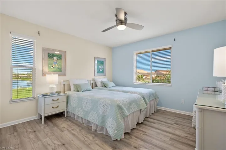 Bedroom with light hardwood / wood-style floors and ceiling fan