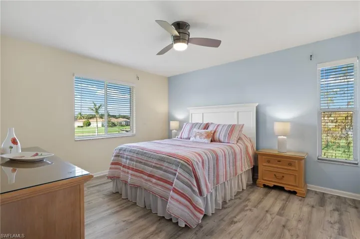 Bedroom with ceiling fan and light wood-type flooring
