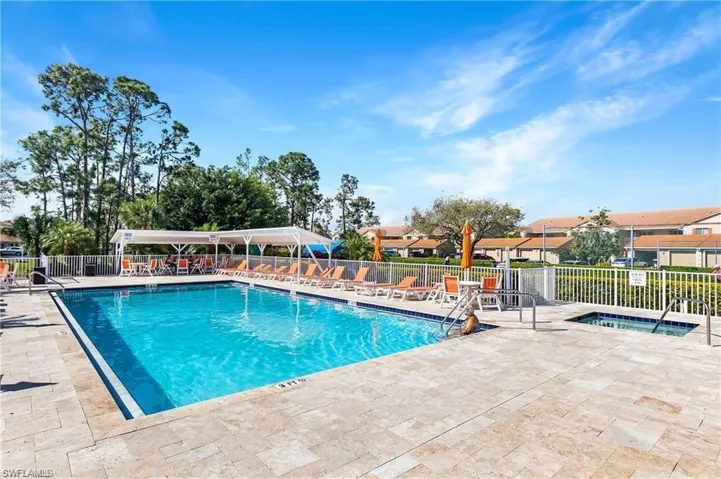 View of pool featuring a community hot tub and a patio