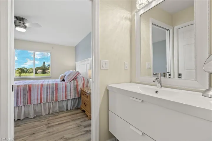 Bathroom with ceiling fan, vanity, and hardwood / wood-style flooring