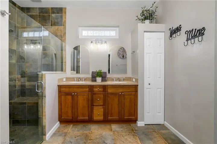 Master Bathroom featuring double vanity and a shower stall