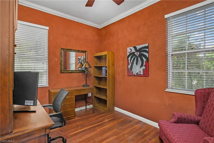 Office area with wood finished floors, crown molding, and ceiling fan