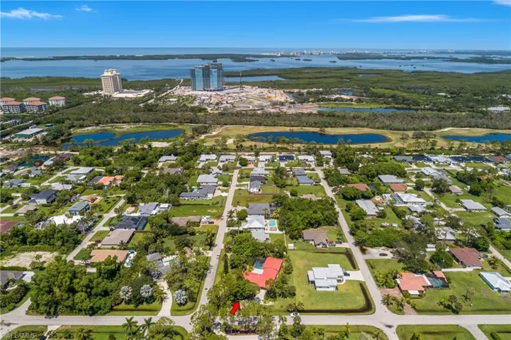 Aerial overview of property's location with a nearby body of water and nearby suburban area