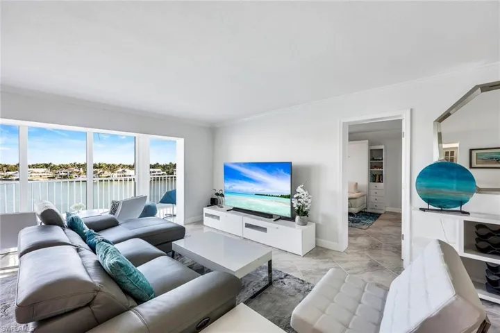 Living room with ornamental molding and baseboards