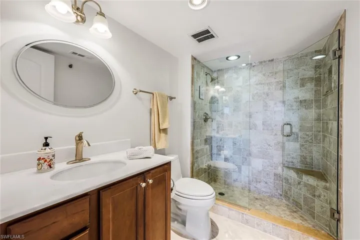 Bathroom with vanity and a shower stall