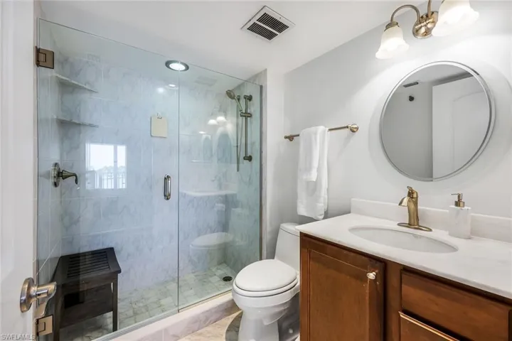 Bathroom with vanity and a shower stall