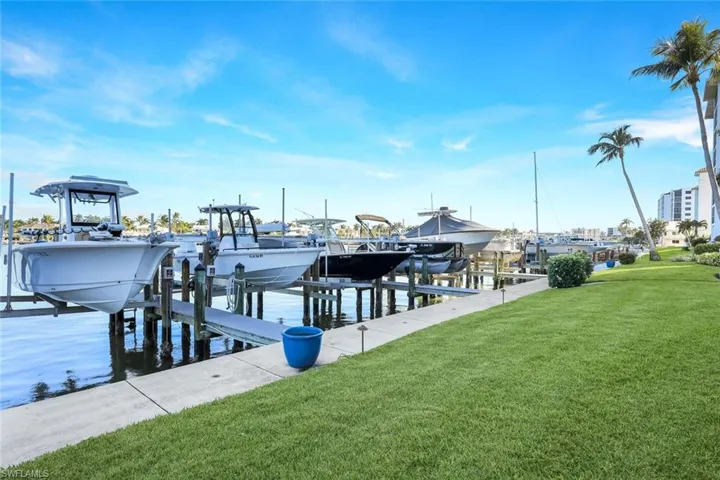Dock featuring a yard, a water view, and boat lift