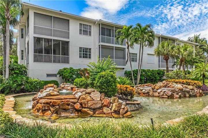 Landscaped area and water feature behind the property