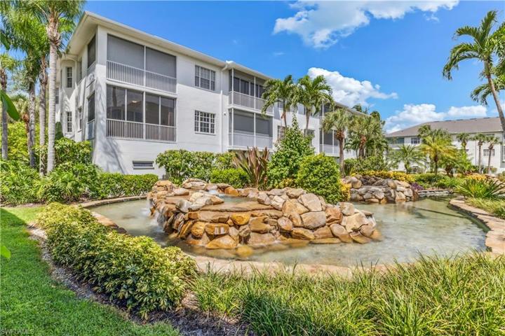 View of screened lanai area of the property overlooking the lagoon style water feature
