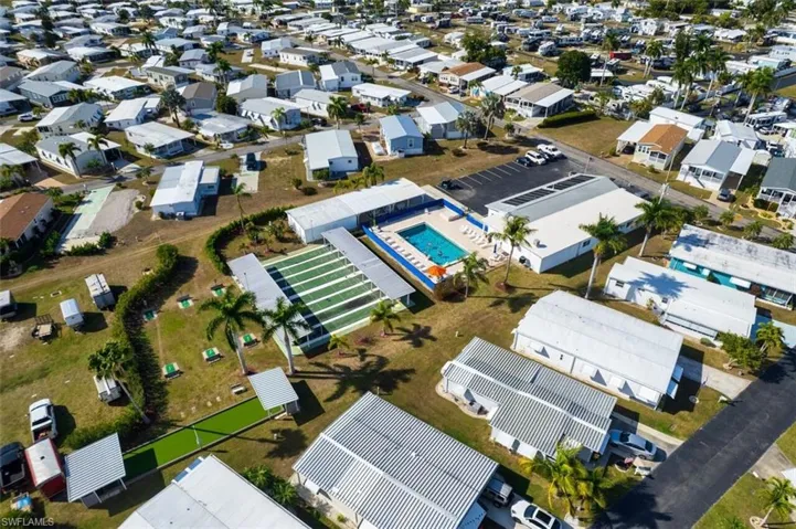 Aerial overview of property's location with nearby suburban area and a pool