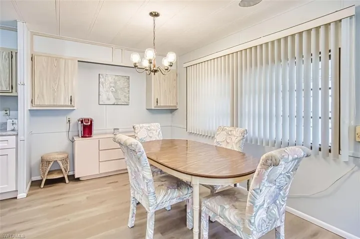 Dining area featuring light wood-style flooring and a chandelier