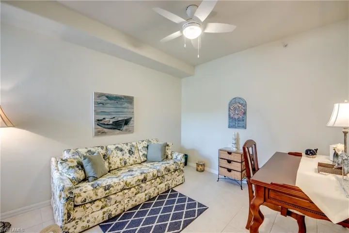 Tiled office space featuring ceiling fan