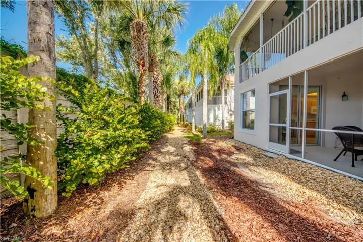 View of yard featuring a balcony and a patio