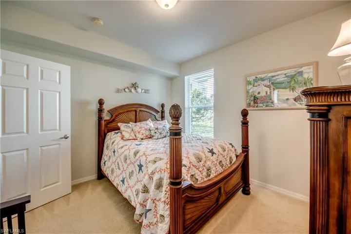 Bedroom with light carpet