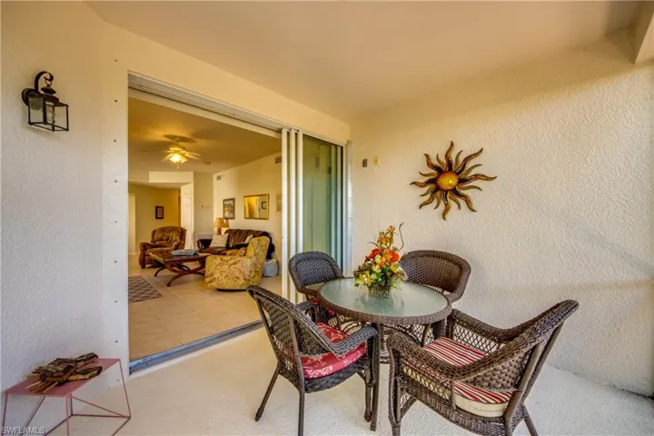 Carpeted dining room featuring ceiling fan