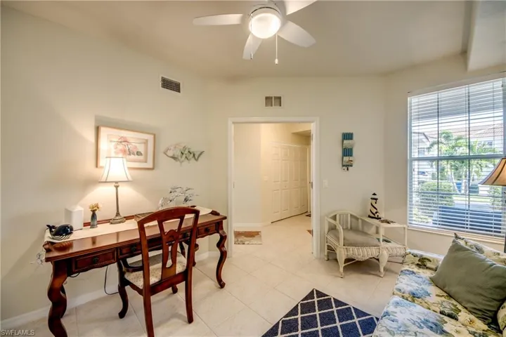 Office space with light tile patterned floors and ceiling fan