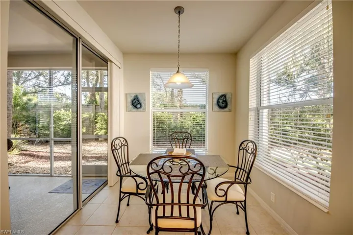Dining space with light tile patterned floors
