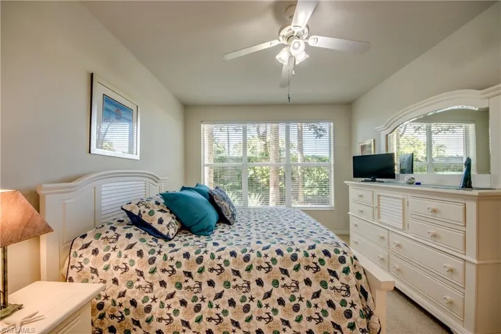 Bedroom with light carpet and ceiling fan