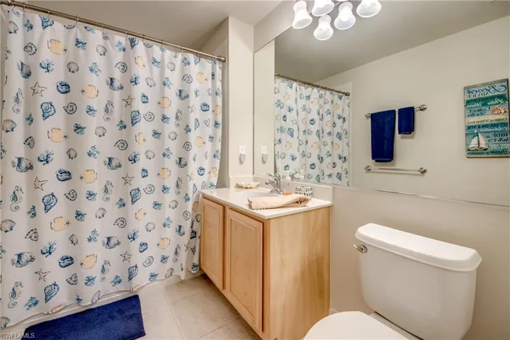 Bathroom featuring tile patterned floors, toilet, and vanity
