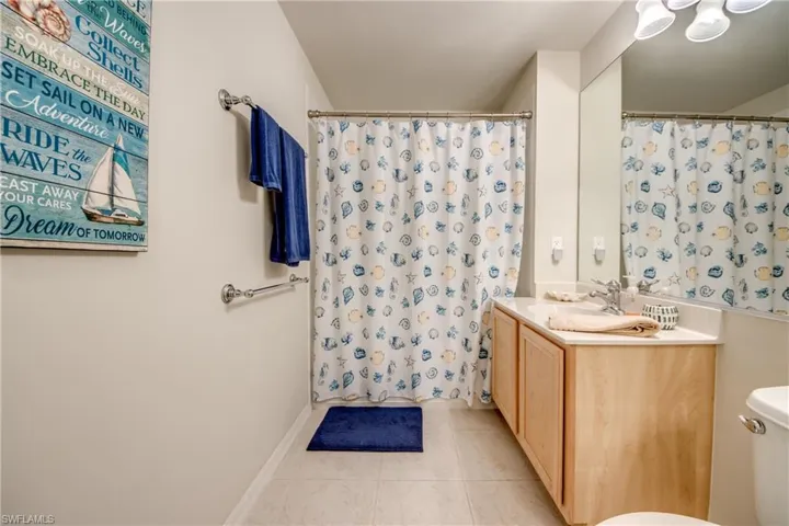 Bathroom featuring vanity, tile patterned floors, and toilet