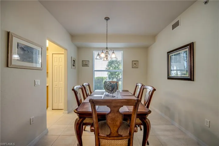 Dining area featuring a notable chandelier and light tile patterned floors