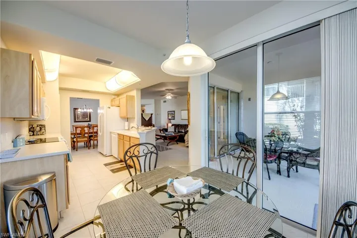 Dining room featuring sink, light tile patterned flooring, and ceiling fan
