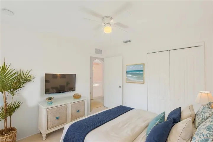 Bedroom featuring a closet, ceiling fan, and light carpet (This photo was virtually staged)