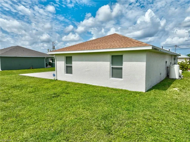 Rear view of property featuring a lawn