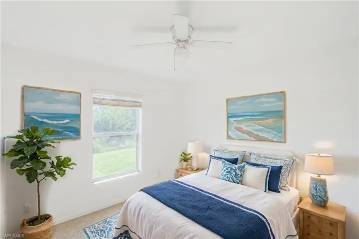 Bedroom with ceiling fan and carpet flooring (This photo was virtually staged)