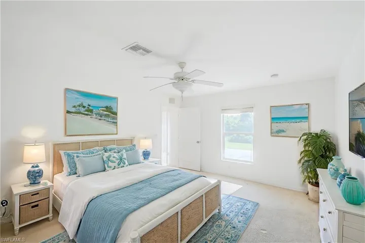 Carpeted bedroom featuring ceiling fan (This photo was virtually staged)