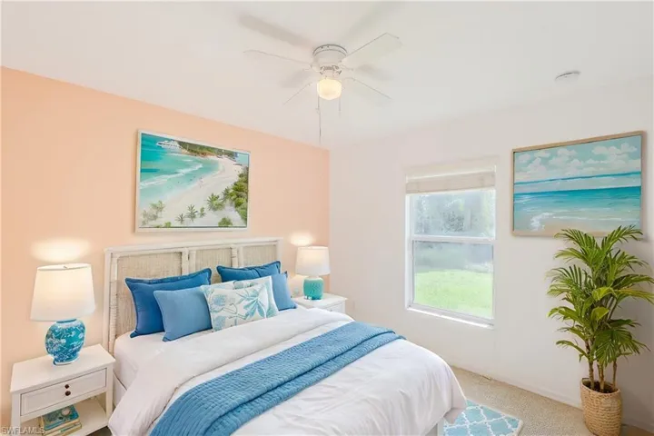 Carpeted bedroom with ceiling fan (This photo was virtually staged)