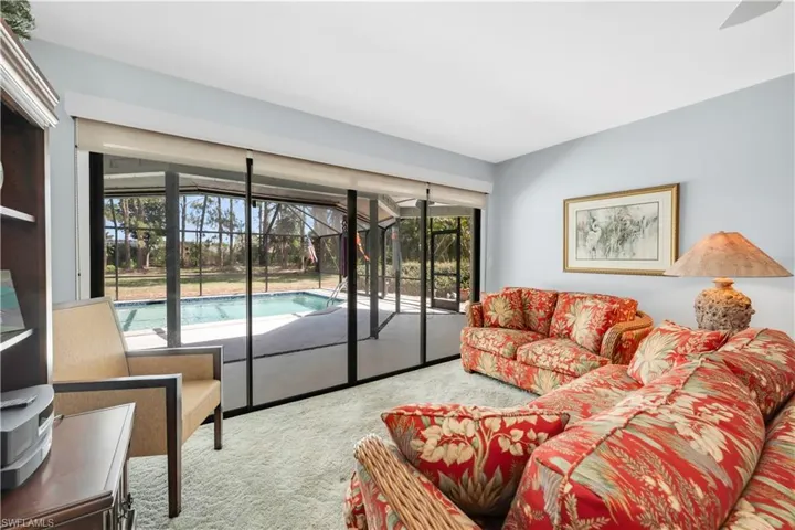 View of carpeted living / dining room with pass through to kitchen