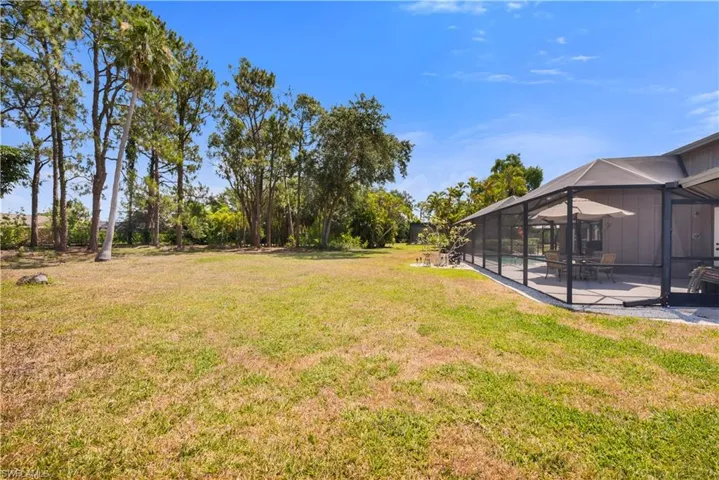 View of lawn featuring a patio area and a lanai