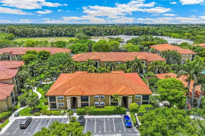 Aerial perspective of the San Mirage residential complex featuring terracotta-style roofing and lush, mature landscaping