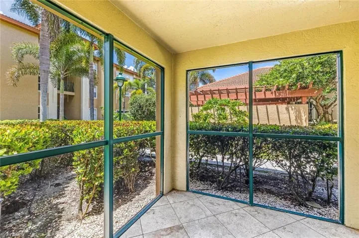 Screened lanai featuring tile flooring and textured walls, and view of the community pool area.