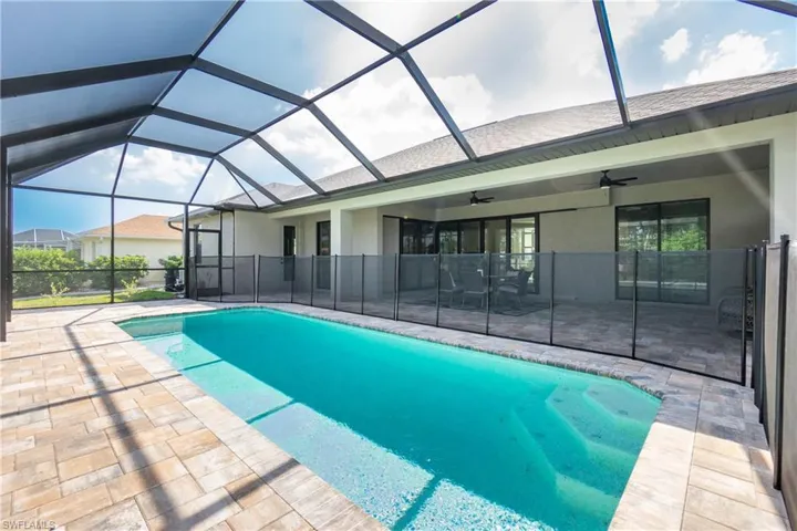 View of pool with a patio area, a lanai, and ceiling fan