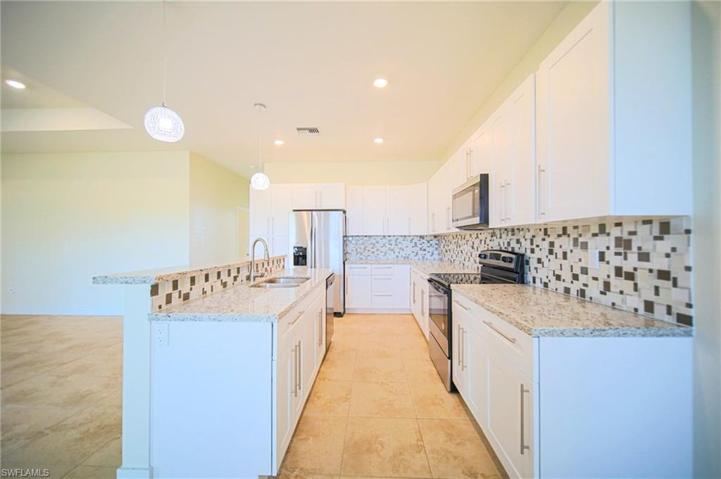 The Island Kitchen Comes With Granite Countertops, Tile Backsplash, Stainless Steel Appliances, And A Floor To Ceiling Pantry!