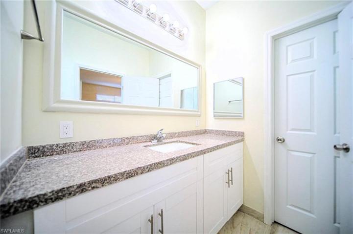 The Master Bathroom Has White Shaker Wood Cabinets, Granite, And A Tile Walk-In Shower!