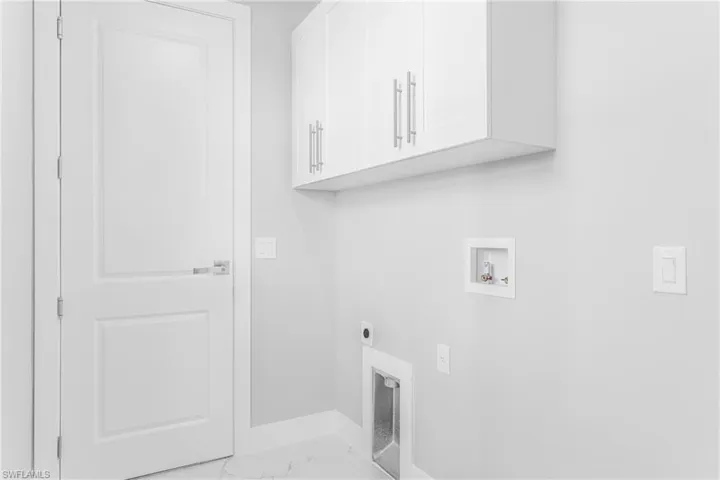 Clothes washing area with hookup for an electric dryer, cabinets, and hookup for a washing machine