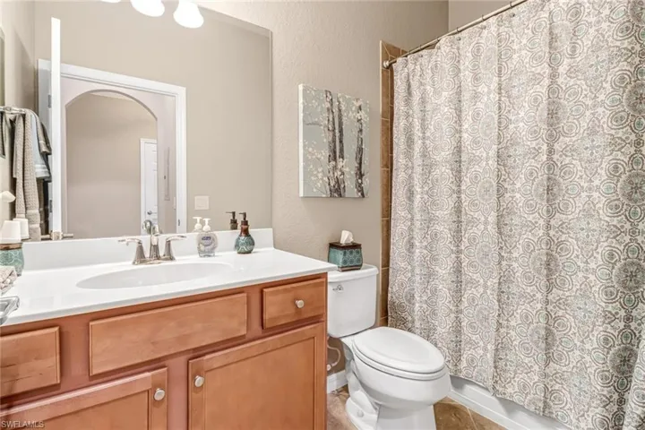 Bathroom with vanity, tile patterned flooring, and toilet