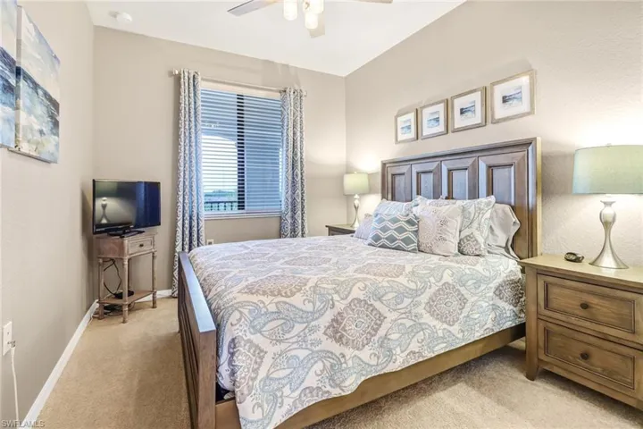 Bedroom featuring light colored carpet and ceiling fan