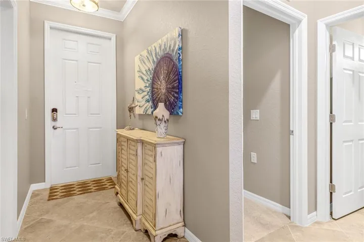 Tiled entryway with crown molding