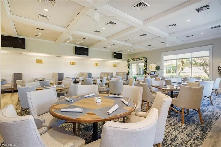 Dining room featuring beamed ceiling, ceiling fan, coffered ceiling, and light hardwood / wood-style floors